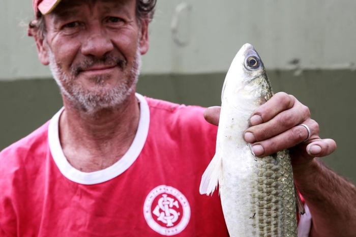 Desempregado, homem pesca no Arroio Dilúvio para ter o que comer